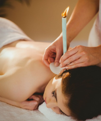 Lady receiving ear candling treatment