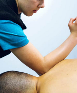 Therapist giving a lady remedial massage
